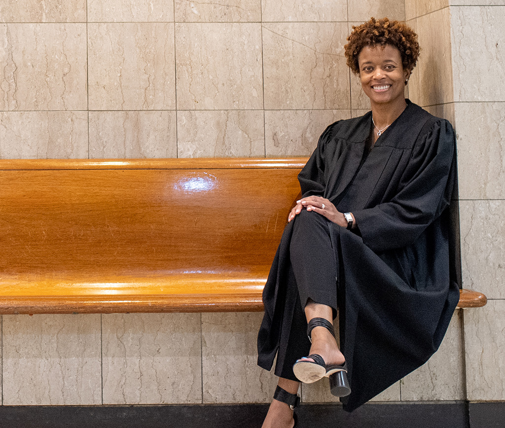 Judge Shartrese Flowers seated on a wooden bench