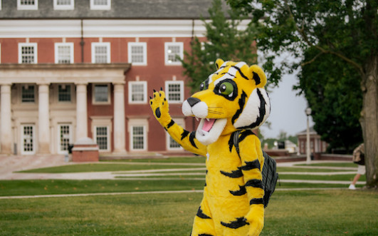 Tyler the Tiger waves to students on the first day of classes.